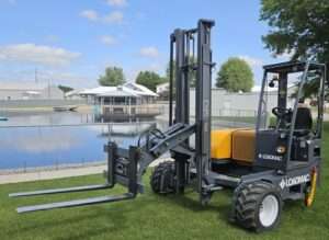 Loadmac 855 2-Way truck-mounted forklift positioned on grass near a pond, showcasing its robust design and dual fork capability, relevant to comparisons with Princeton PB55.3x piggyback forklift.